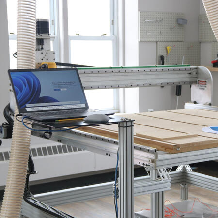 A well exposed commercial photograph of a CNC router and workspace.